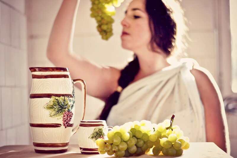 woman with grapes and pitcher