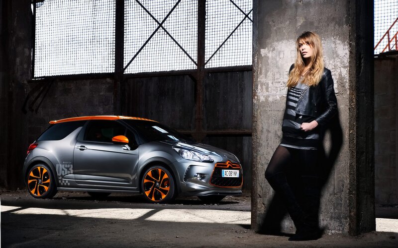 Woman with gray car in warehouse