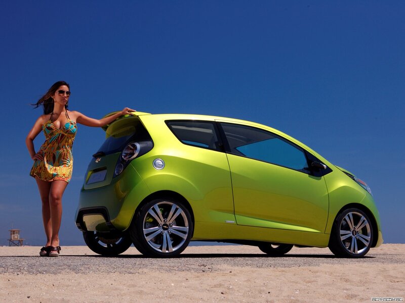Woman with green car on beach