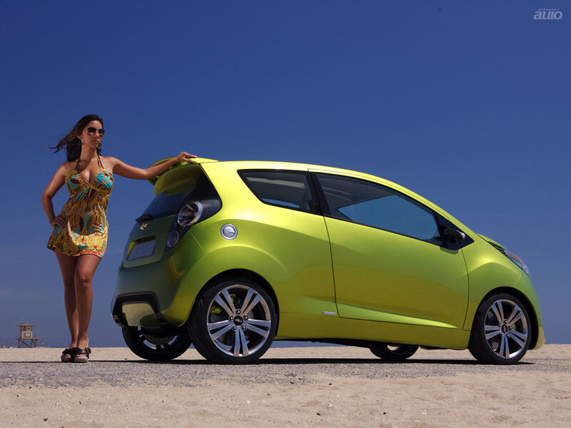 Woman with green car on beach