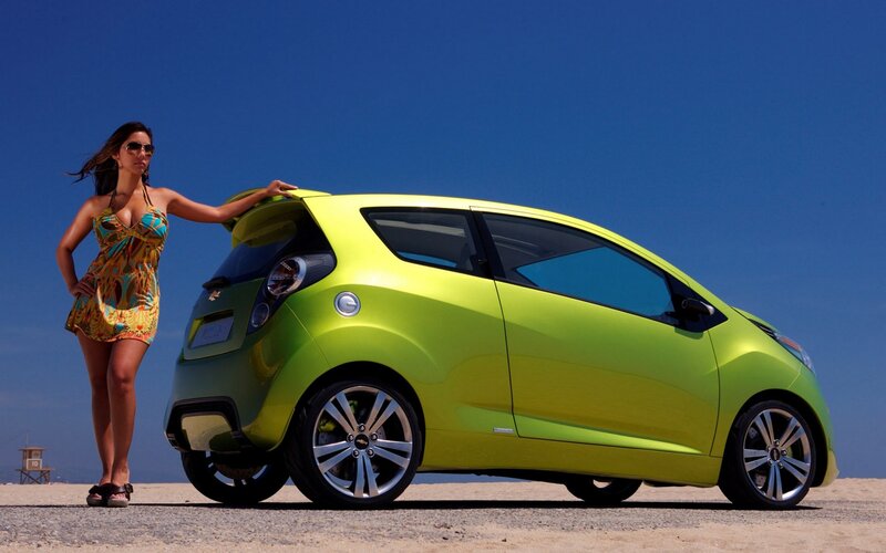 Woman with green car on beach