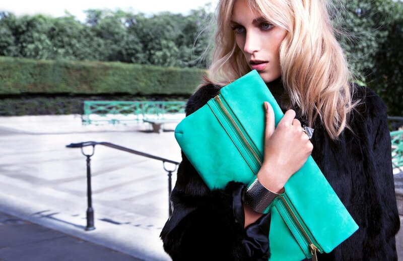 Woman with green clutch bag