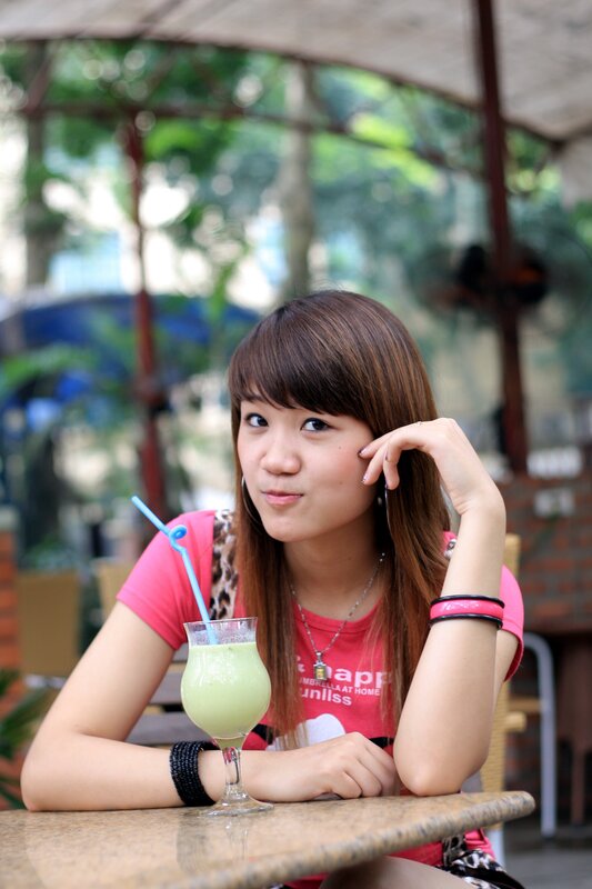 woman with green drink at cafe