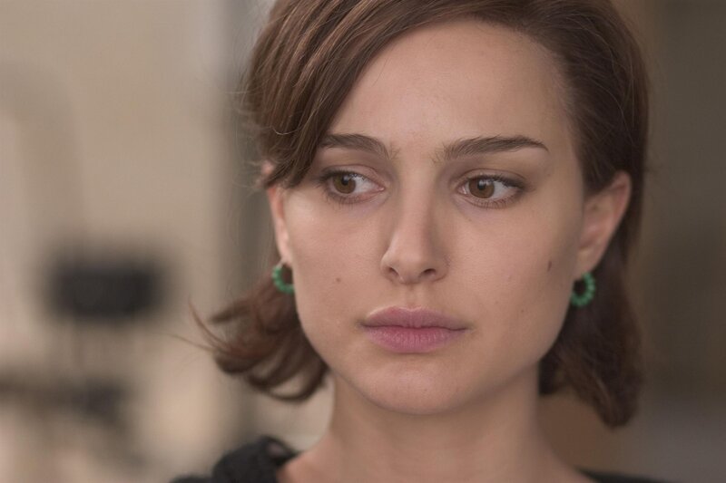 woman with green earrings