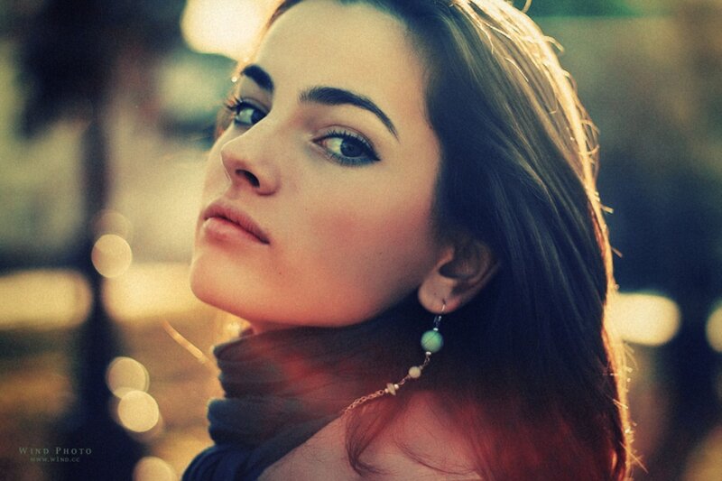 woman with green earrings