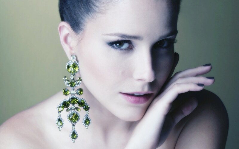woman with green earrings