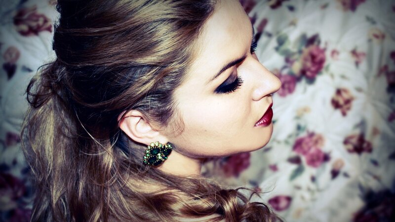 woman with green earrings