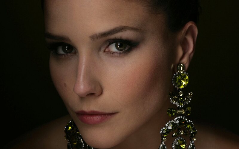 woman with green earrings