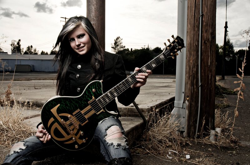 woman with green electric guitar