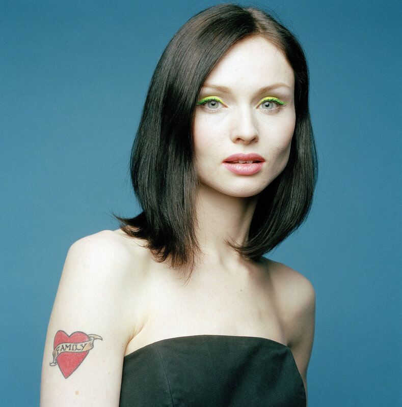 woman with green eyeliner and tattoo