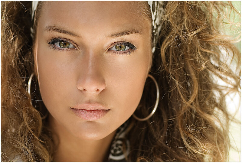 woman with green eyes and curly hair