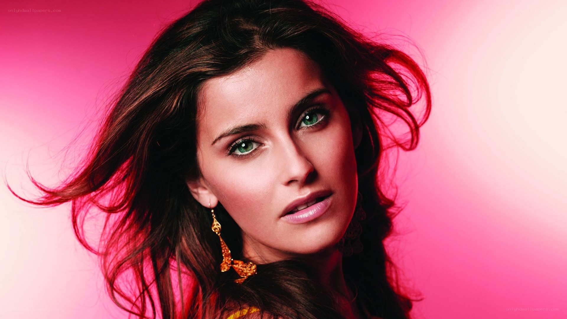woman with green eyes and pink background