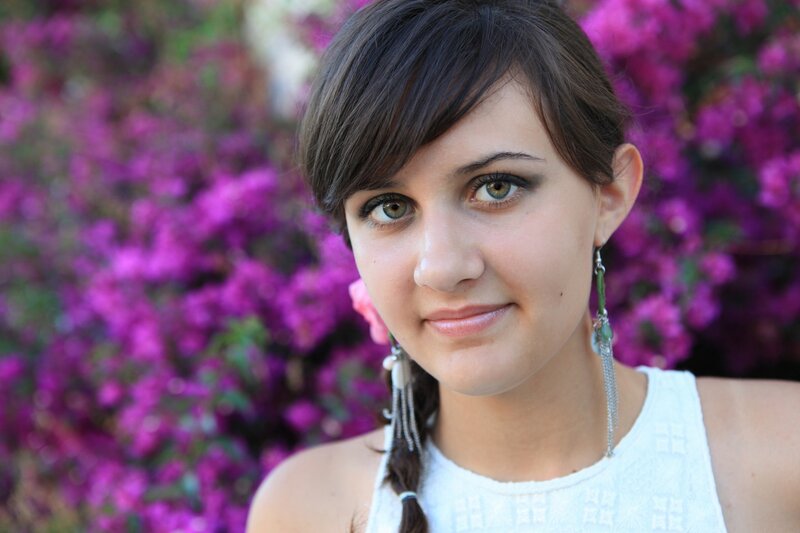 woman with green eyes and purple flowers