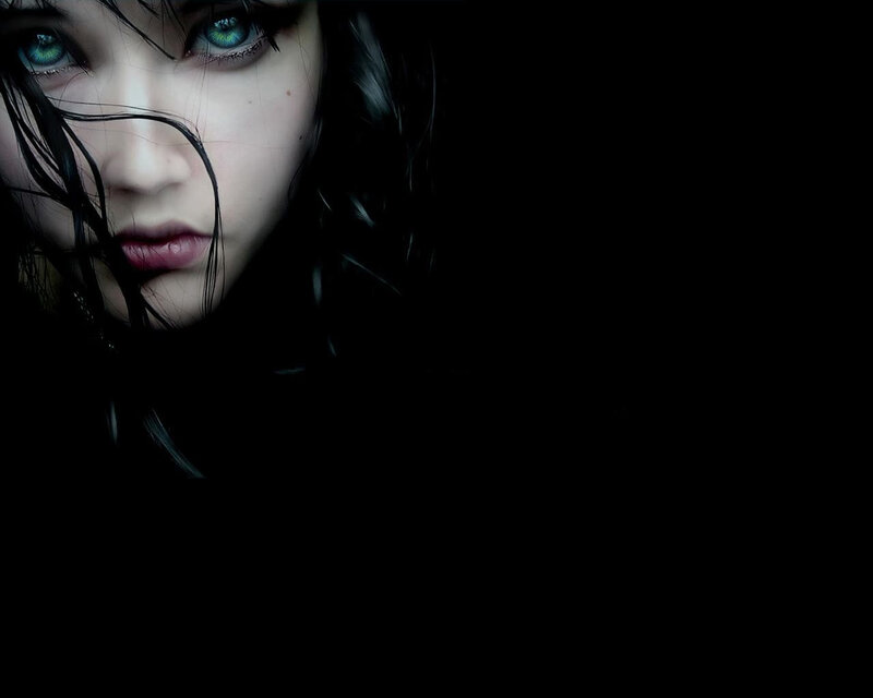 woman with green eyes in darkness