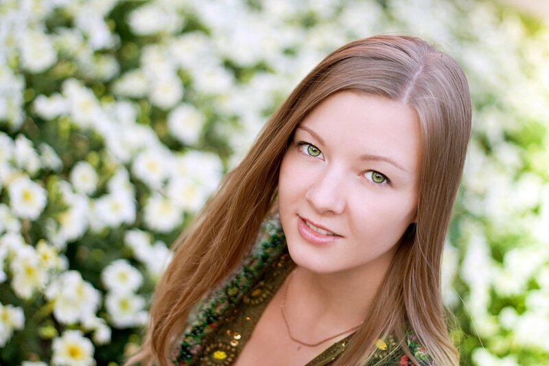 woman with green eyes in flower garden