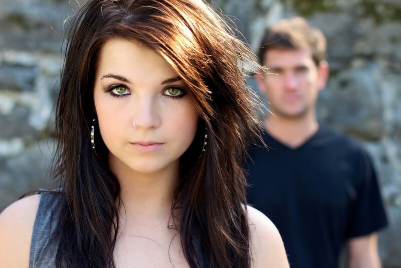 woman with green eyes in front of man