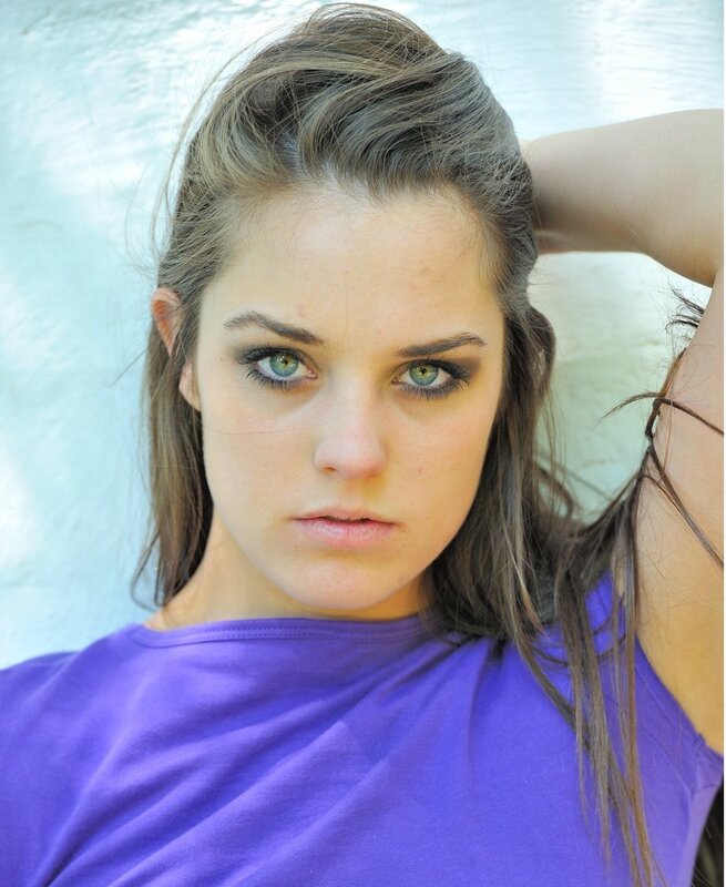 woman with green eyes in purple shirt