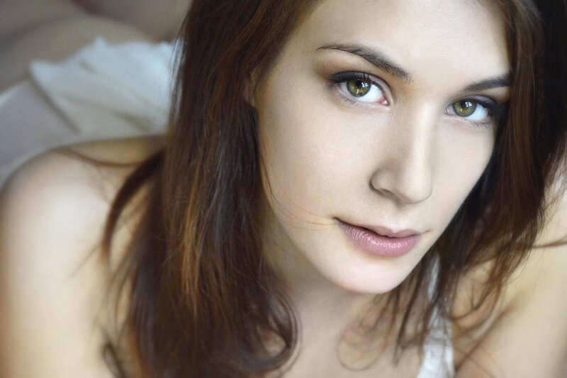 woman with green eyes lying down