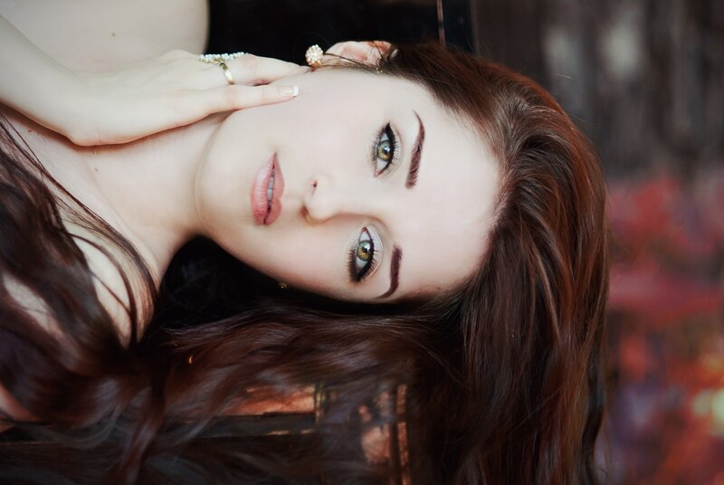 woman with green eyes lying down