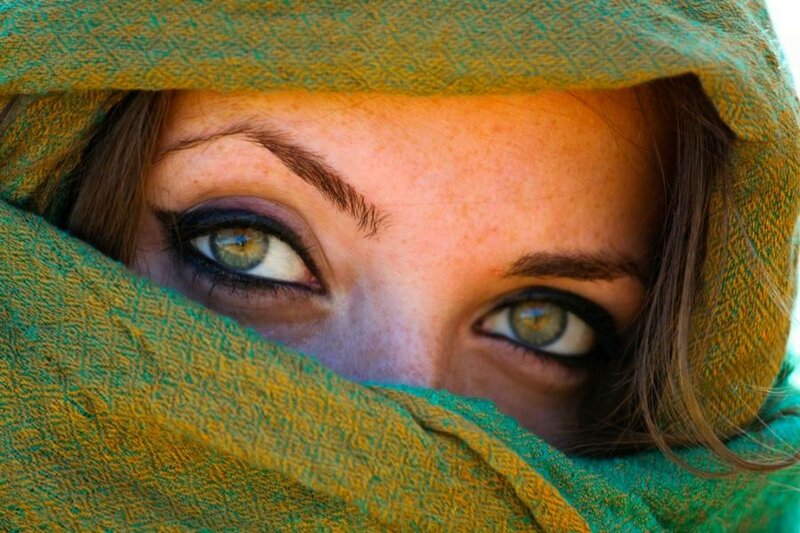 woman with green eyes under a scarf