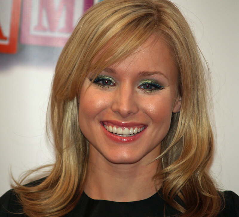 woman with green eyeshadow smiling