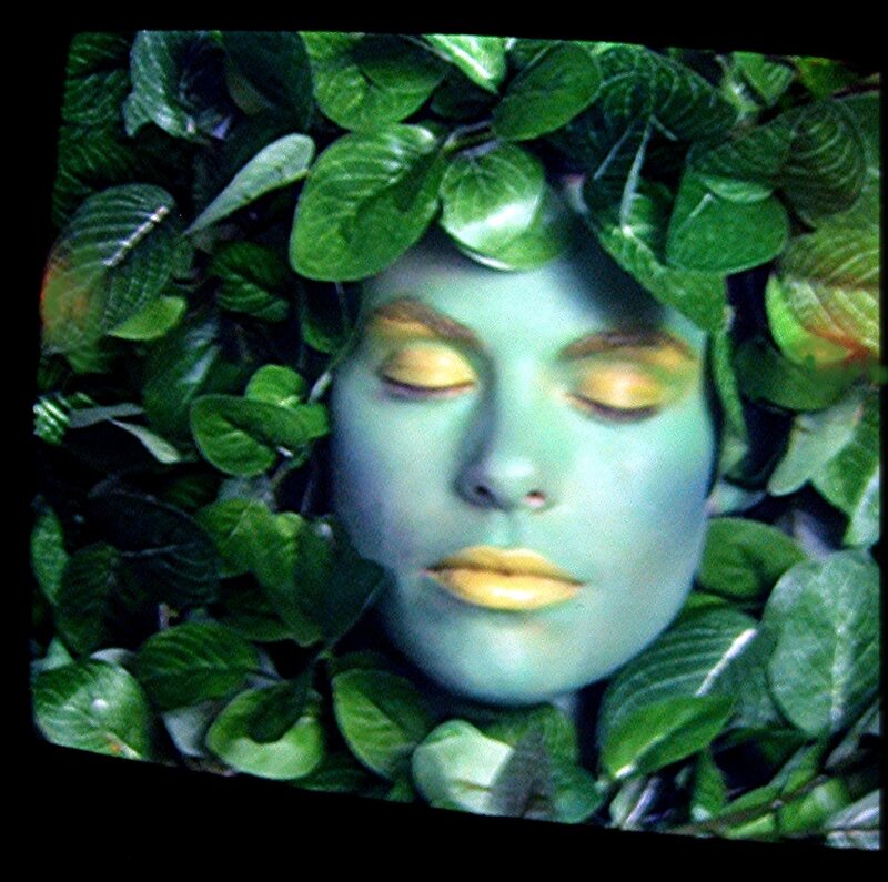 woman with green face and leaves