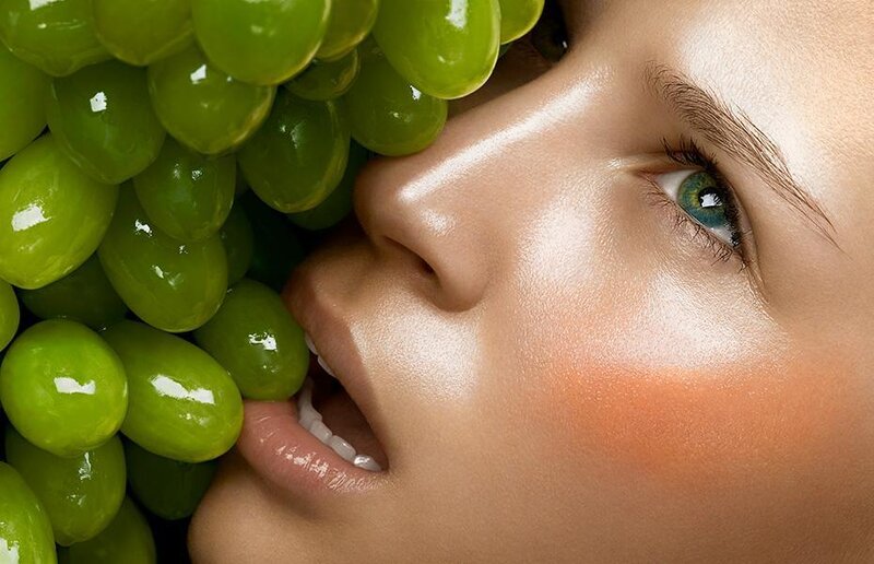 woman with green grapes