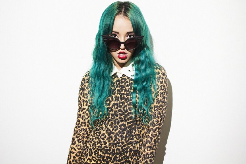 woman with green hair and sunglasses