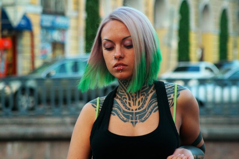 woman with green hair and tattoos