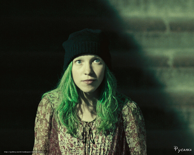 woman with green hair in dark room