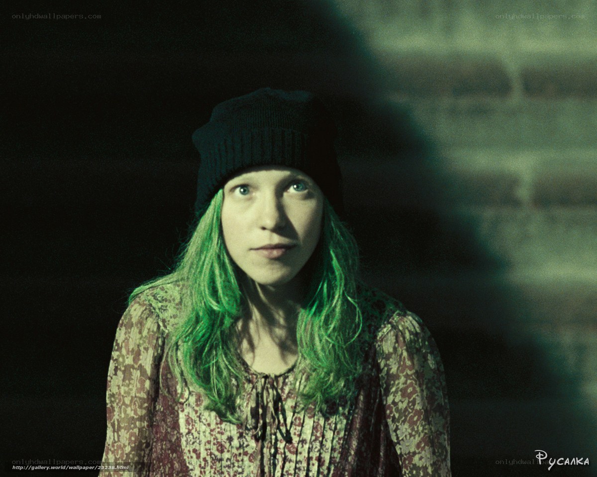 woman with green hair in dark room