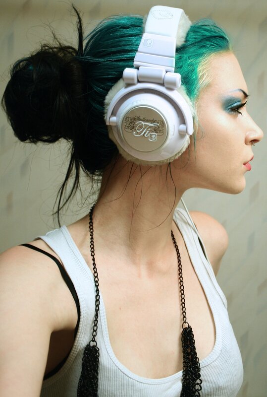 woman with green hair wearing headphones