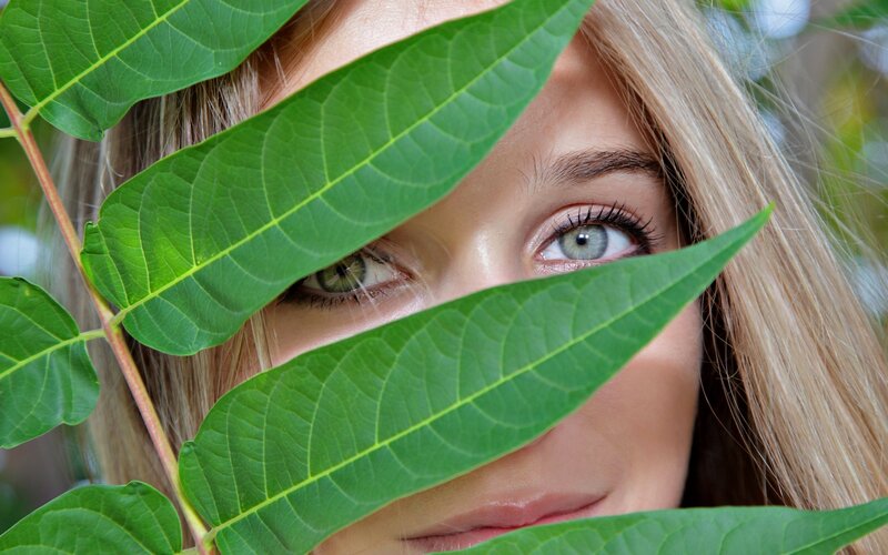 woman with green leaves