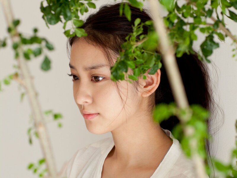 woman with green leaves