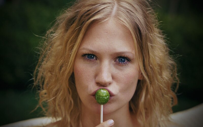 woman with green lollipop
