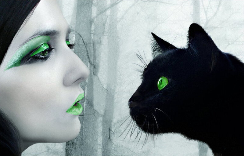 woman with green makeup and black cat