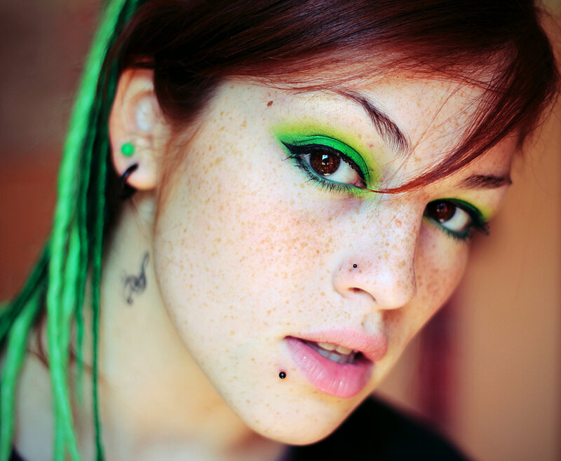 woman with green makeup and dreadlocks