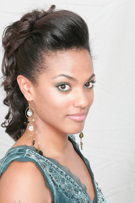 woman with green makeup and earrings