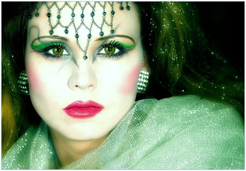 woman with green makeup and headpiece
