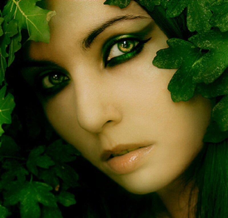 woman with green makeup and leaves