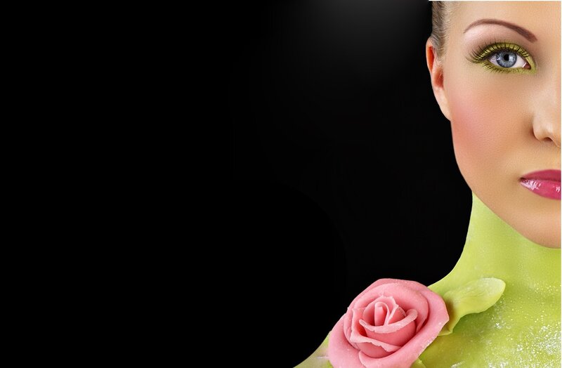 woman with green makeup and rose