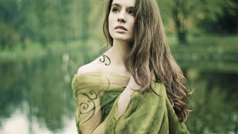 woman with green scarf in forest