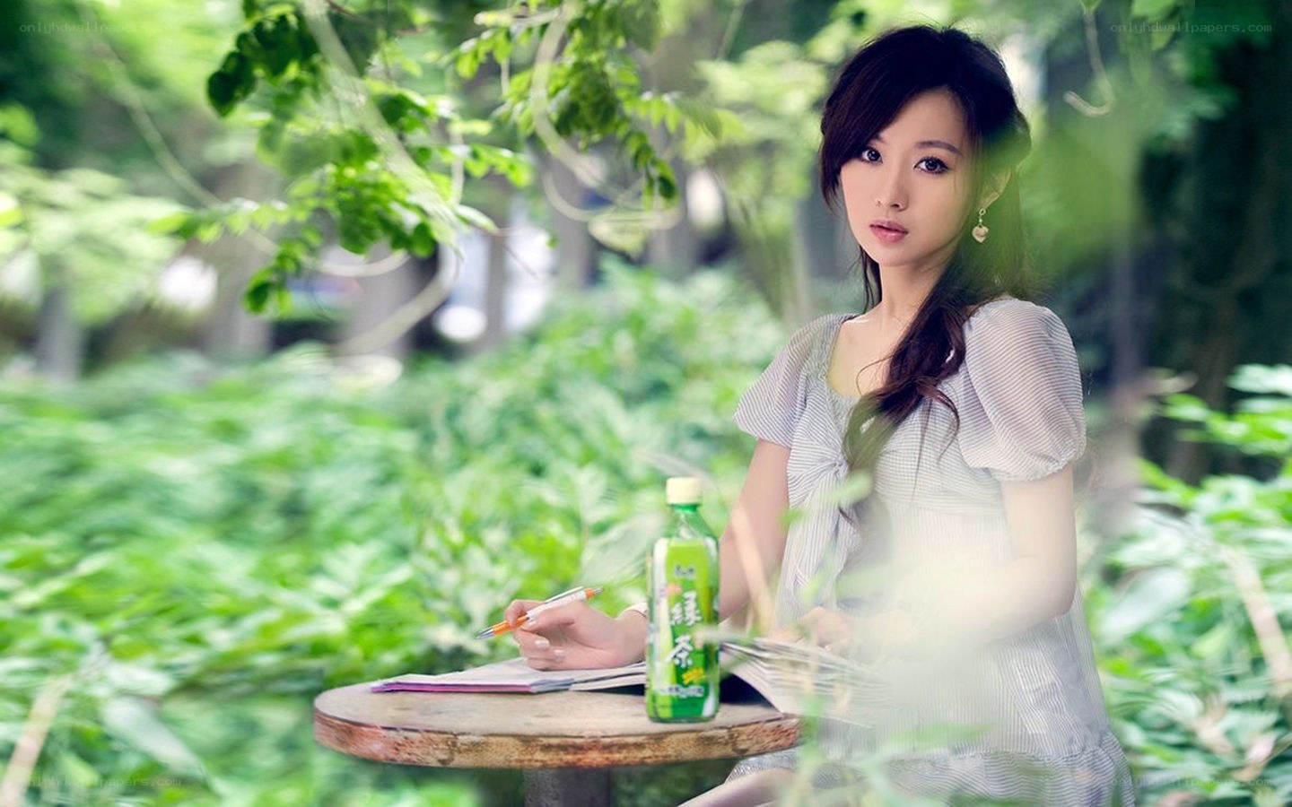 Woman with green tea bottle