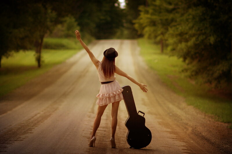 Woman with Guitar Case — Green, Serene