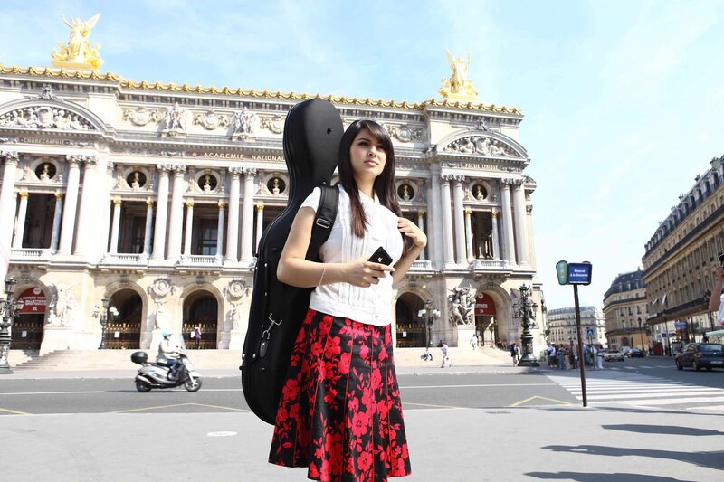 Woman with guitar case in Paris