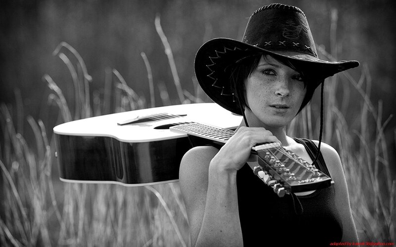 woman with guitar in field