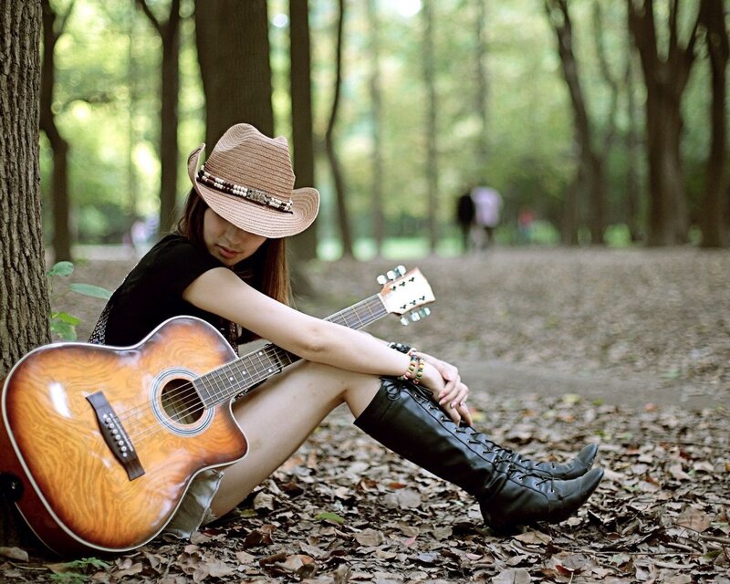 Woman with Guitar in Forest — Brown, Serene