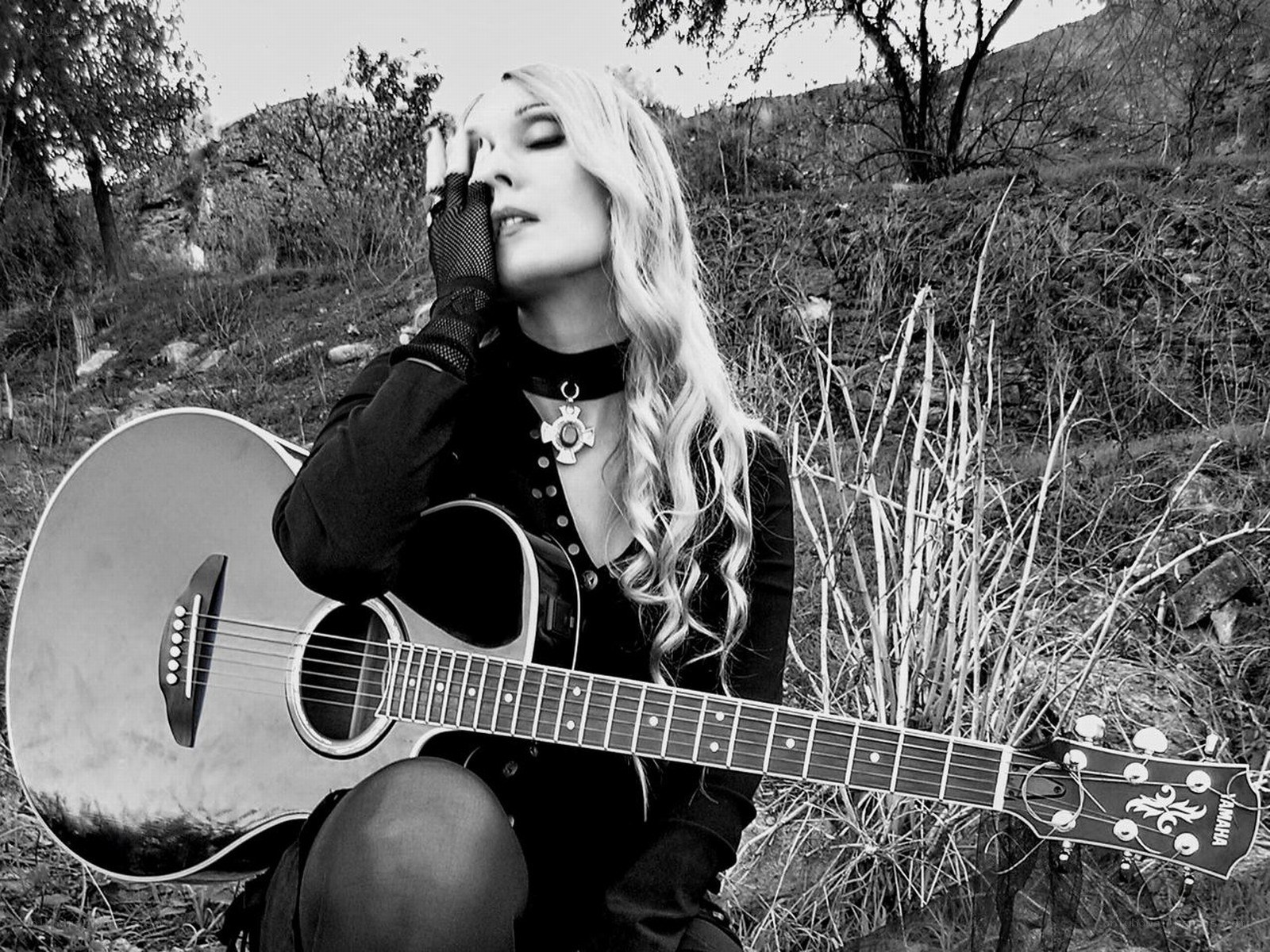 woman with guitar in nature