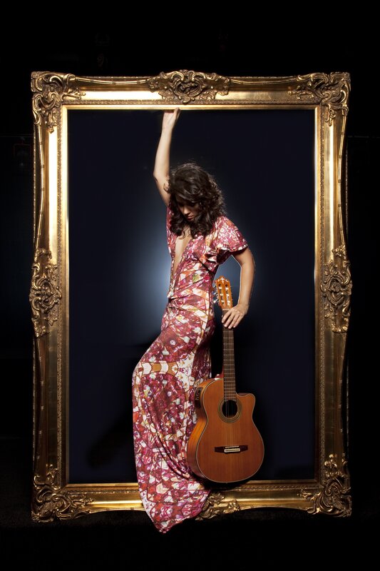 Woman with guitar in ornate frame