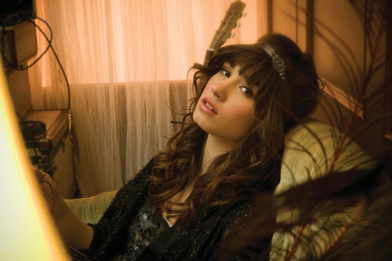 woman with guitar in warm light